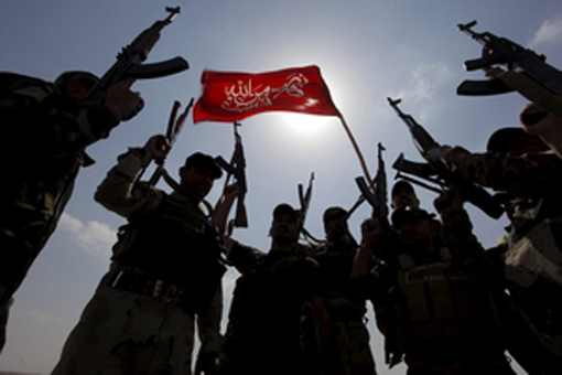 Hashid Shaabi forces allied with Iraqi forces chant slogans against the Islamic State in Tikrit