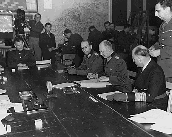 Actul capitulării Germaniei (07 - 08 mai 1945) - Generalul colonel Alfred Jodl semnând actele capitulării la Cartierul General Aliat de la Reims - foto preluat de pe ro.wikipedia.org