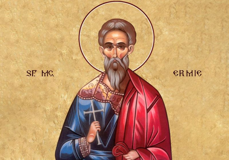 Icoană a Sfântului Mucenic Ermie, reprezentat cu aureolă, ținând o cruce în mână, simbol al martiriului creștin.